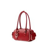Amazing Song red leather handbag with heart charm and double handles on white background