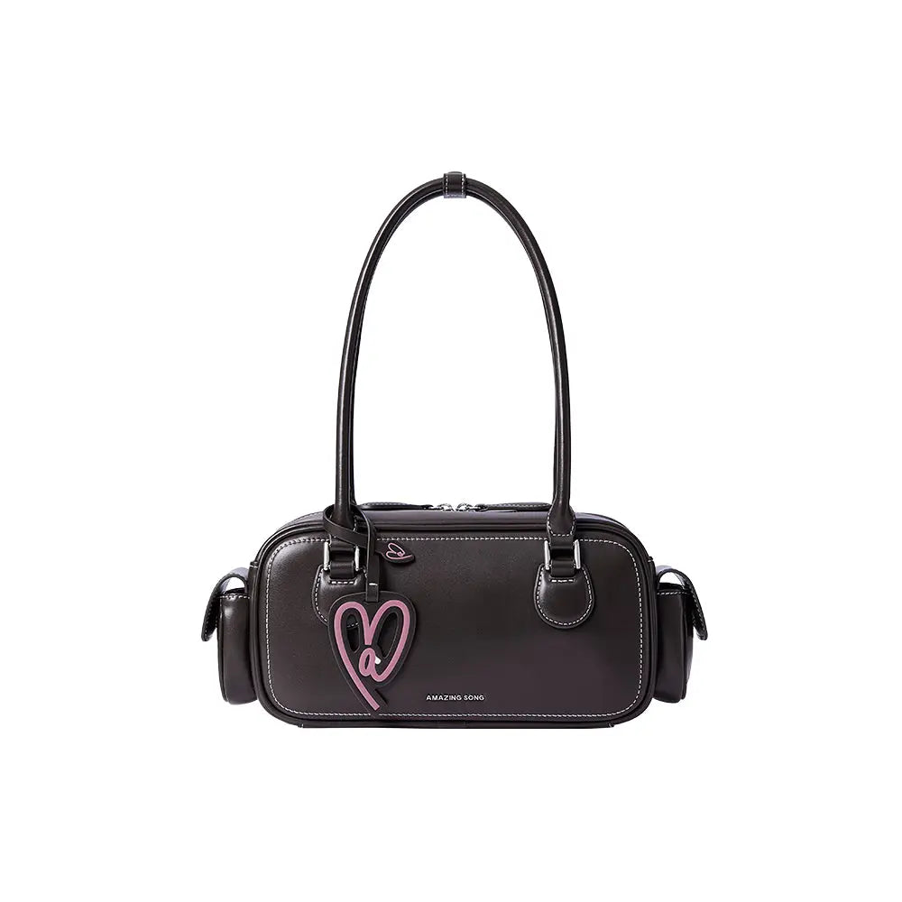 Amazing Song black handbag with double straps and pink heart accent on white background