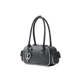 Amazing Song black shoulder bag with heart charm and white trim on white background