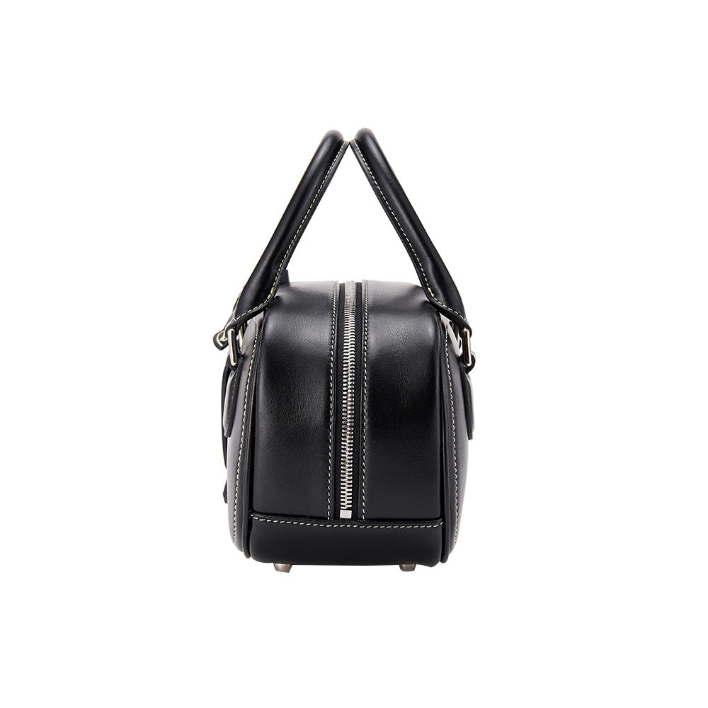 Side view of a black leather handbag with white stitching and silver zipper, Amazing Song