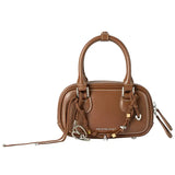 Amazing Song brown leather handbag with double handles and decorative charms on white background