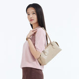 Woman in pink top carrying beige handbag, Amazing Song official website style