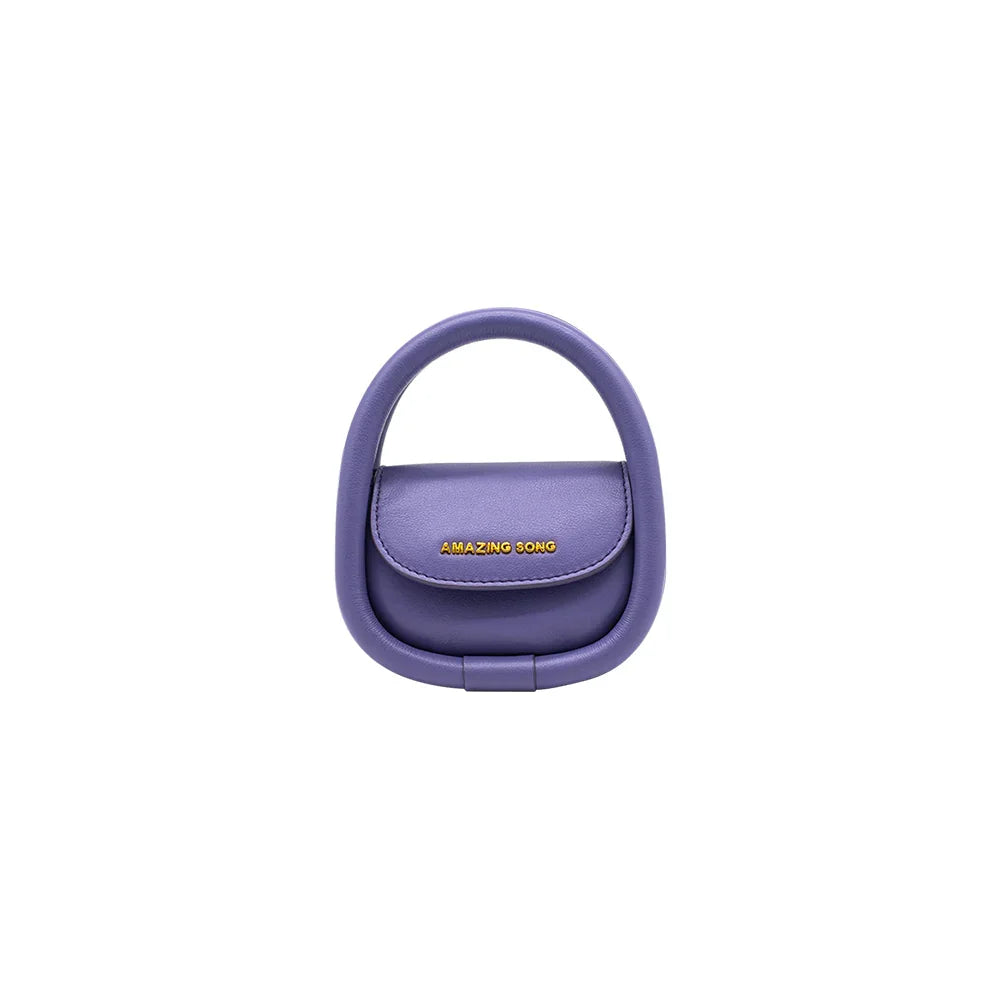 Amazing Song purple designer handbag with circular handle on white background