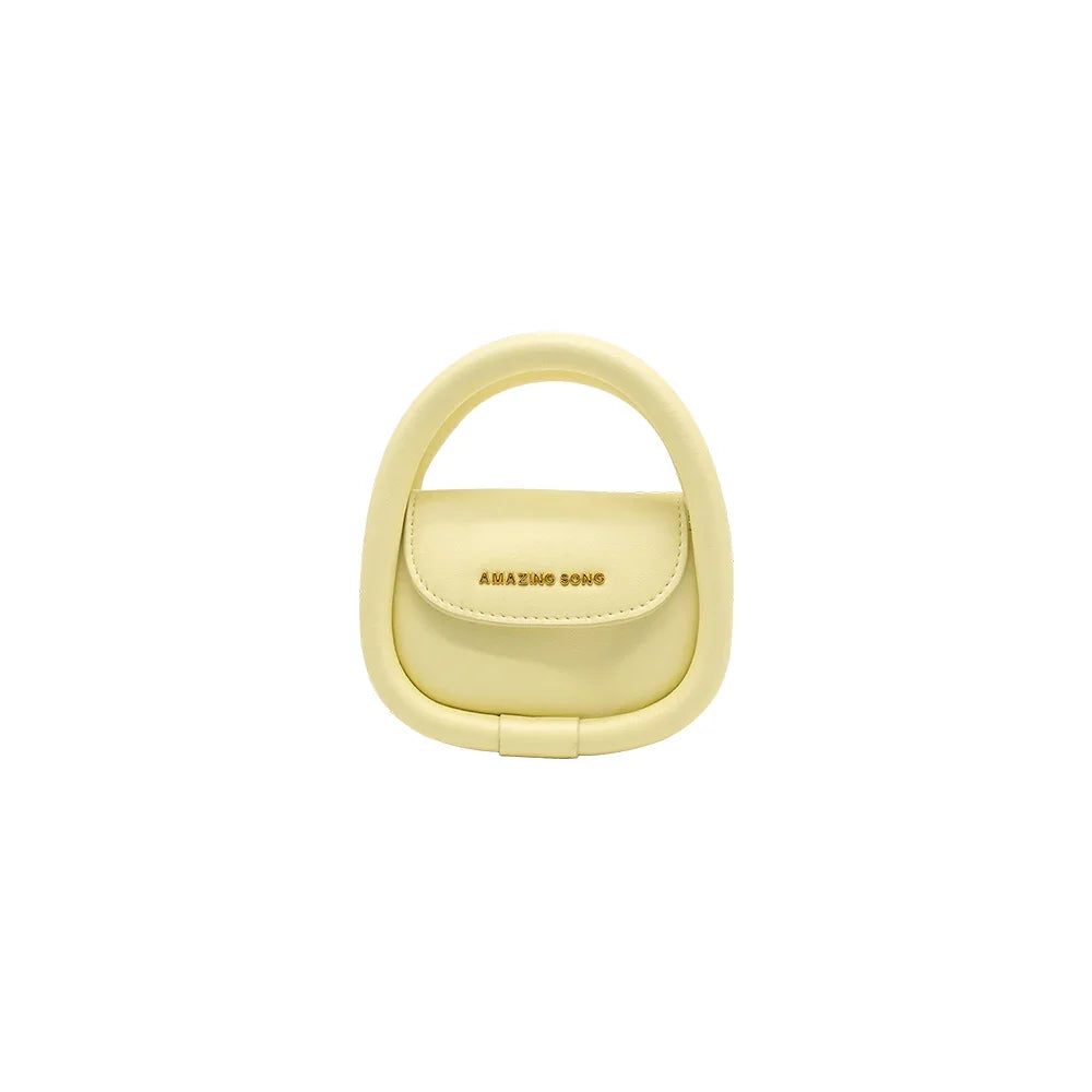 Amazing Song yellow mini handbag with rounded handle on white background