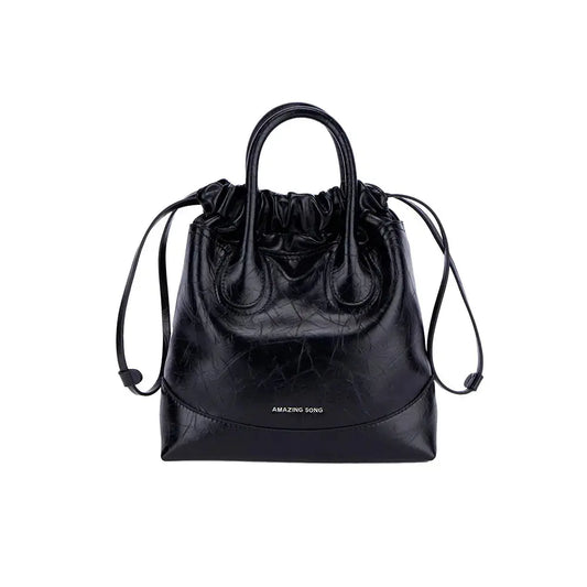 caramel hobo bag in warm-toned top-grain cowhide leather resting on an autumn coat