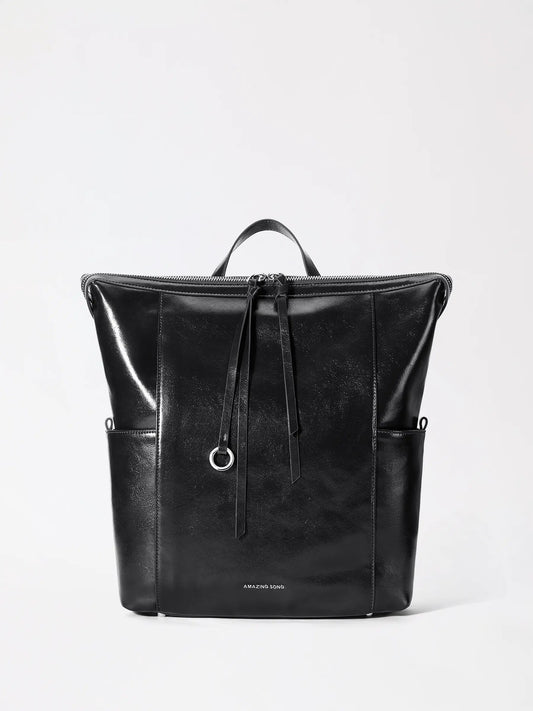A structured donut-inspired leather backpack in warm tan leather