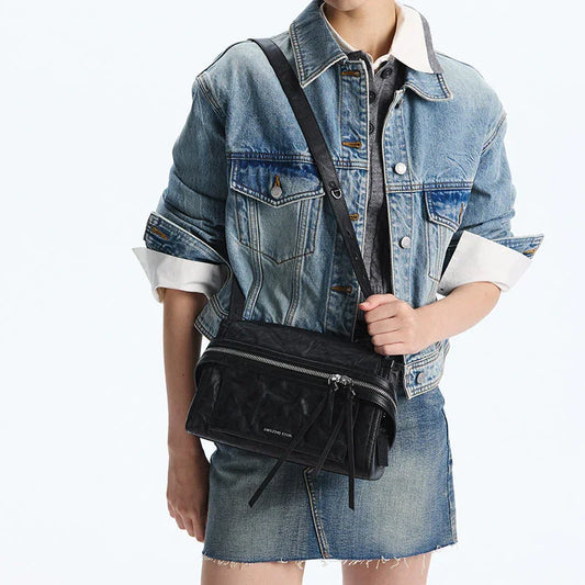 Woman wearing denim jacket and skirt with black Amazing Song crossbody bag