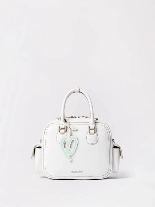 A warm tan toast-shaped leather bag with a top handle and long strap