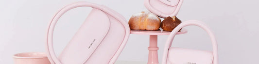 Pink Amazing Song handbags on pastel stand with bread, minimalist aesthetic