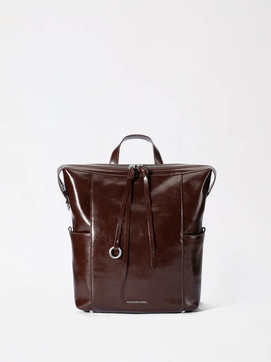 Small donut backpack in tan genuine leather shown from the front with rounded bakery-inspired shape