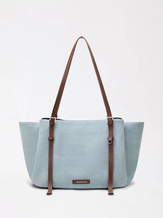 A denim and canvas tote with playful donut inspiration in soft blue