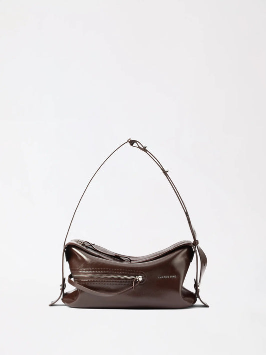 AMAZING SONG liqueur bag in soft caramel top-grain leather photographed at a casual angle