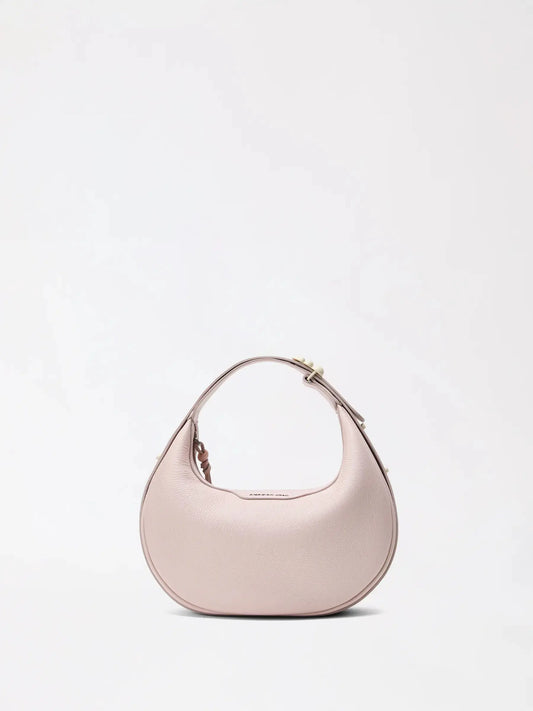 Small half-moon leather bag in warm tan with top handle raised