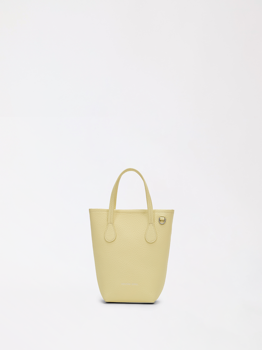 Top-grain leather bucket bag with shoulder strap ready for a long outdoor music festival day