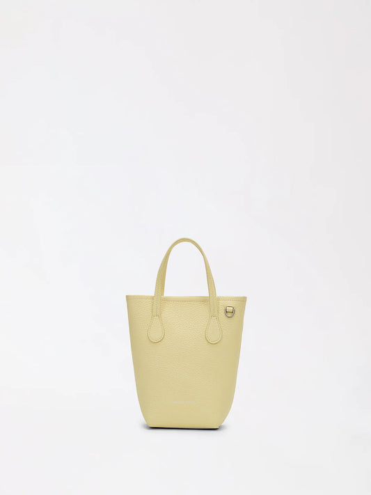 Top-grain leather bucket bag with shoulder strap ready for a long outdoor music festival day