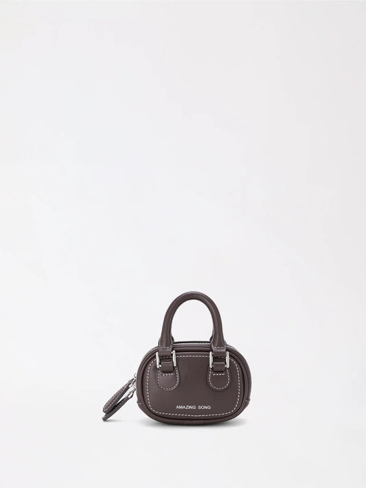 A small cute-shaped leather bag inspired by a slice of toast in warm tan