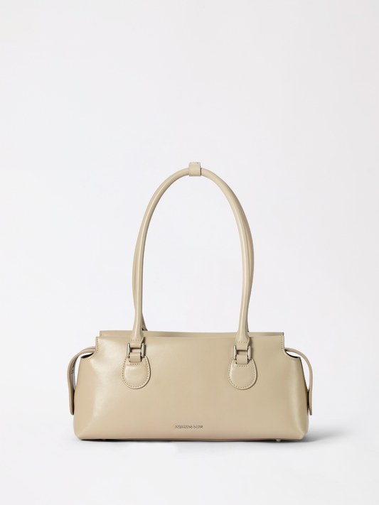 Top-grain leather toast pillow pack bag photographed flat showing its padded rounded silhouette