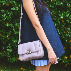 Woman wearing a denim dress with a lavender shoulder bag, Amazing Song accessories