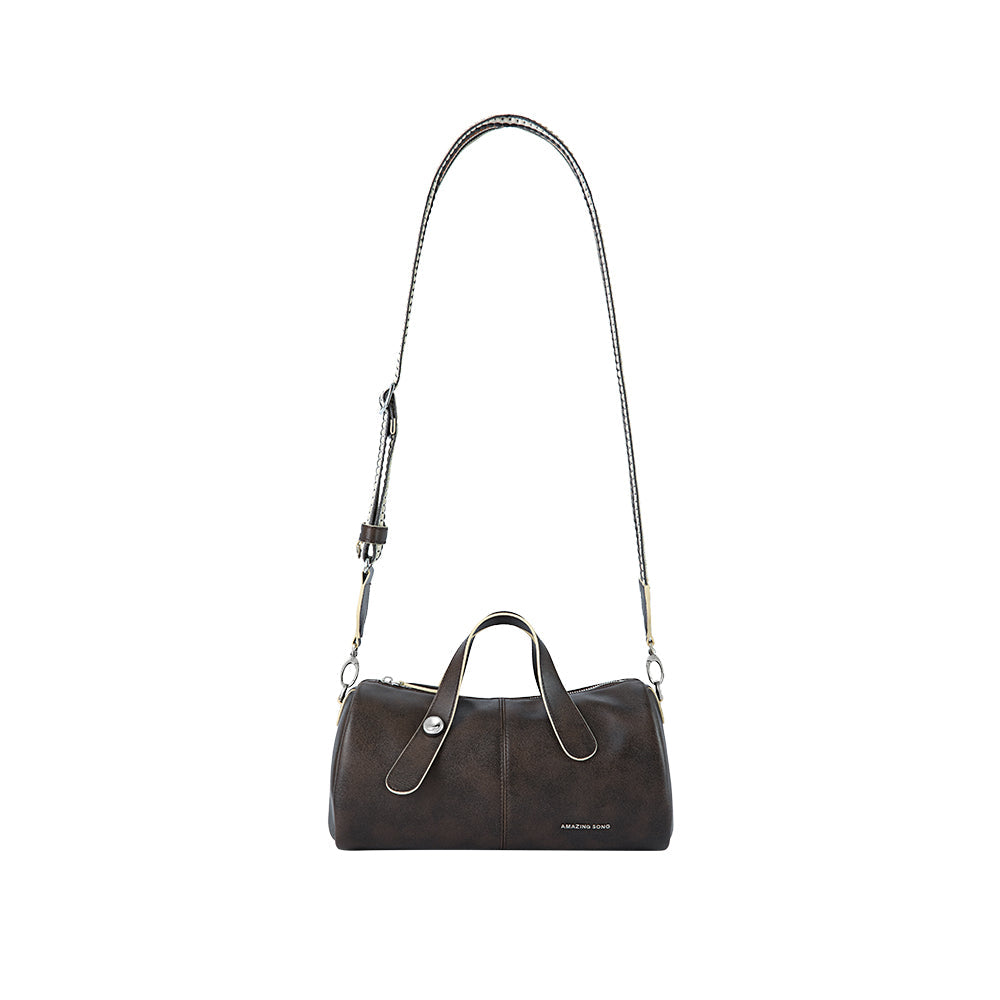 Amazing Song brown leather handbag with long adjustable strap on white background