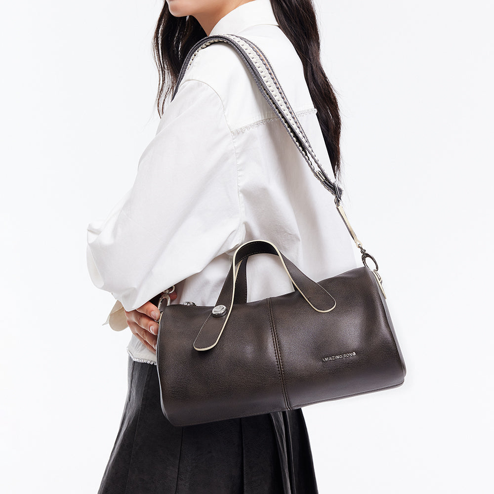 Woman carrying dark brown Amazing Song handbag with white shirt and black skirt