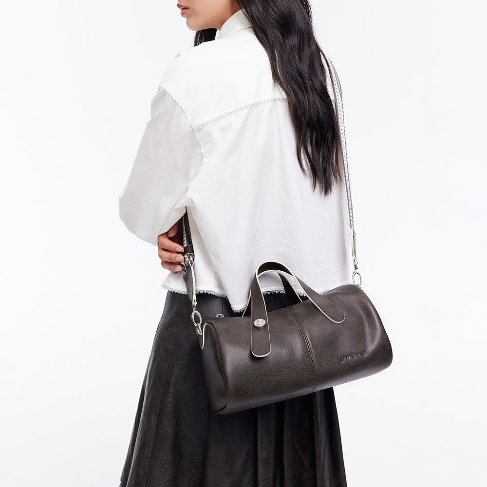 Woman in white blouse carrying black leather handbag, Amazing Song official website style