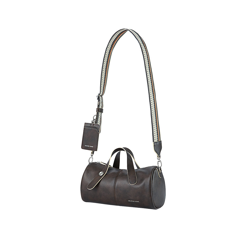 Amazing Song brown leather duffel bag with striped shoulder strap and logo tag