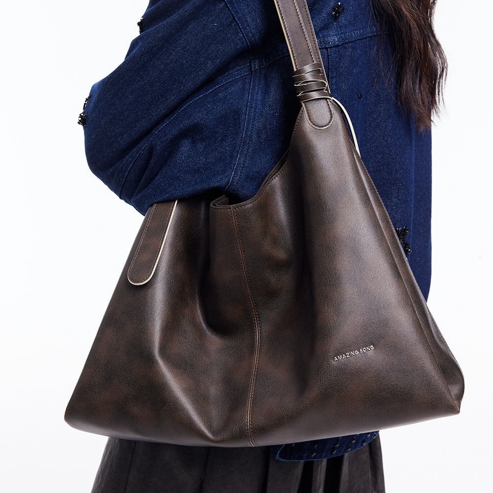 Amazing Song brown leather shoulder bag on model in blue denim jacket