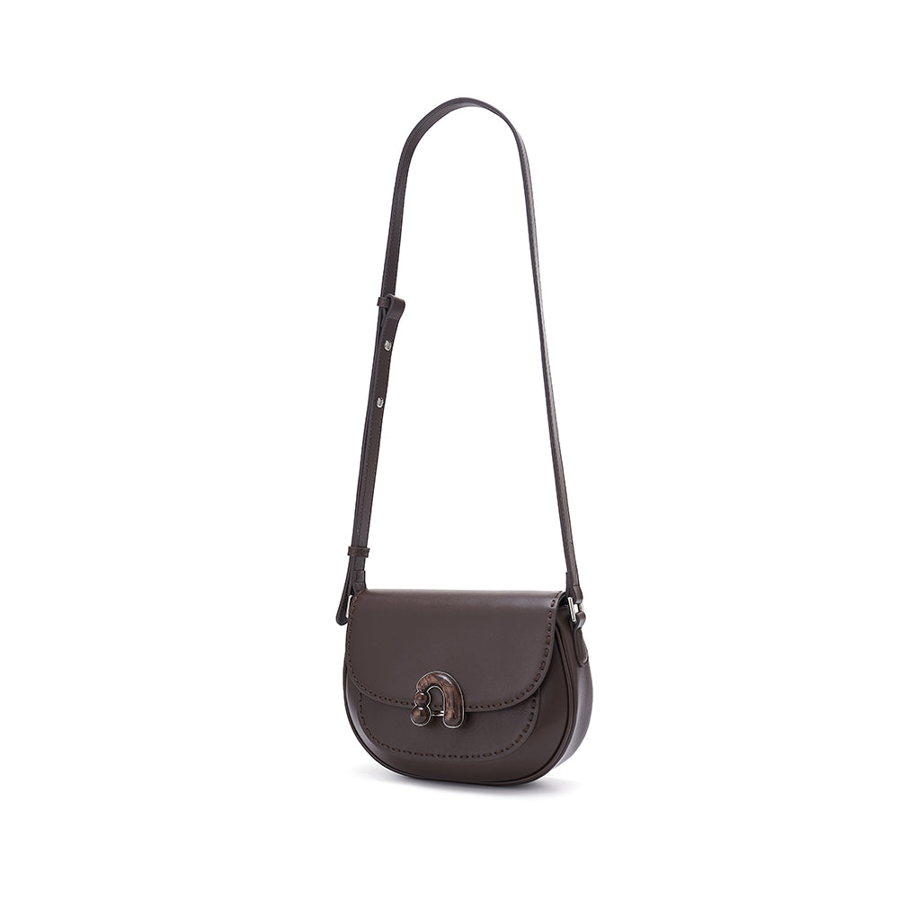 Dark brown leather crossbody bag with adjustable strap and metal clasp on white background