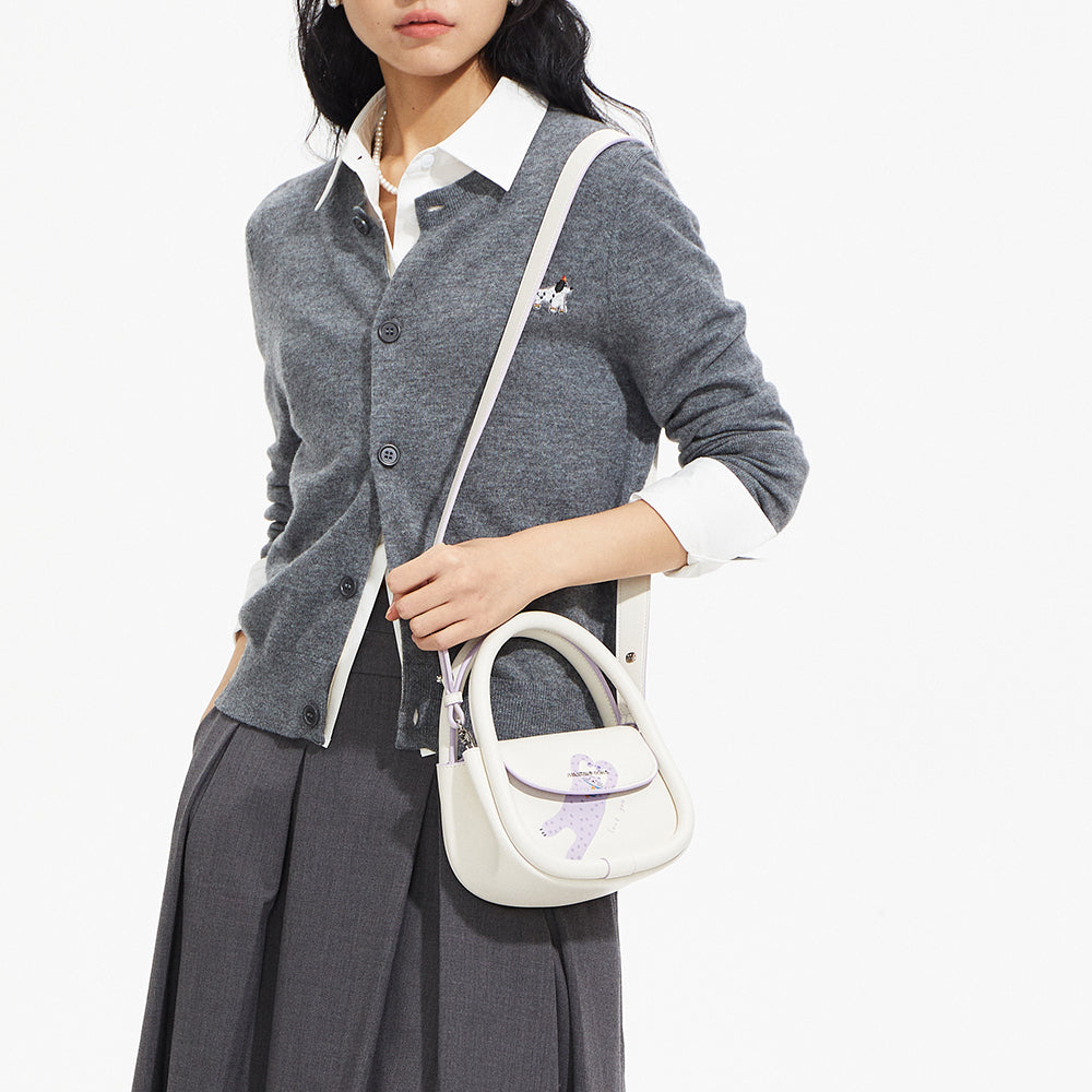Woman wearing grey cardigan and skirt with white crossbody handbag, Amazing Song style