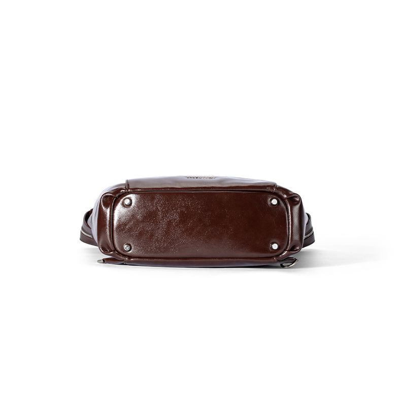 Bottom view of a dark brown leather bag with silver feet, Amazing Song official website