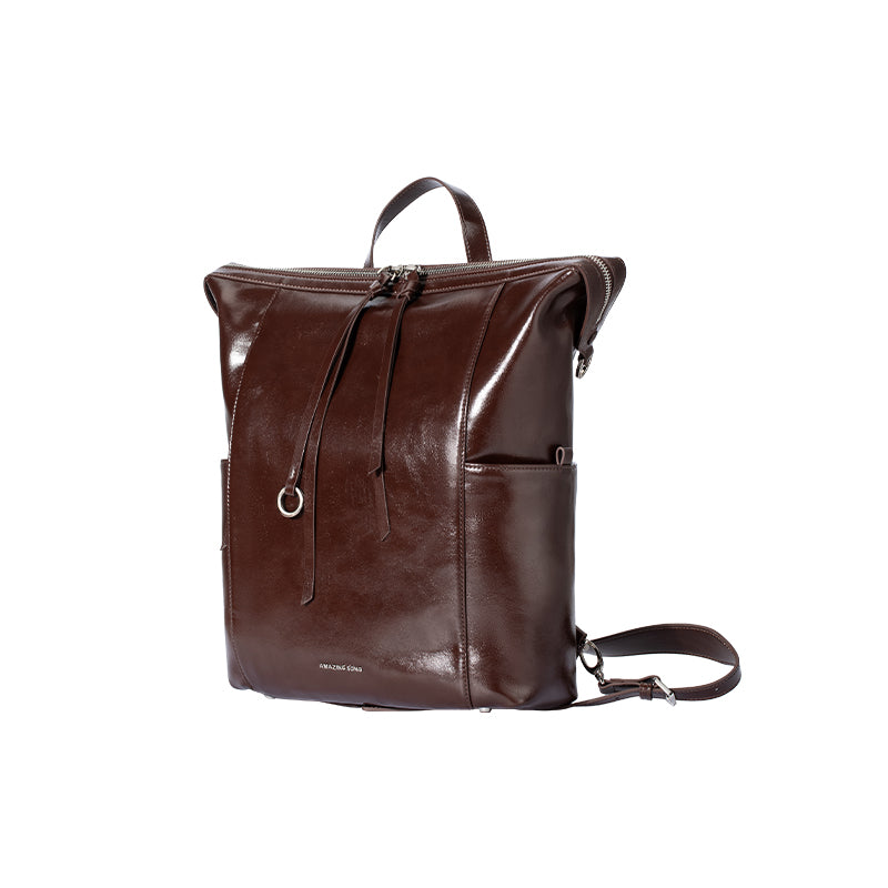 Amazing Song brown leather backpack with top handle and side pockets on white background