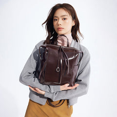 Woman holding stylish dark brown leather backpack, Amazing Song brand, studio background