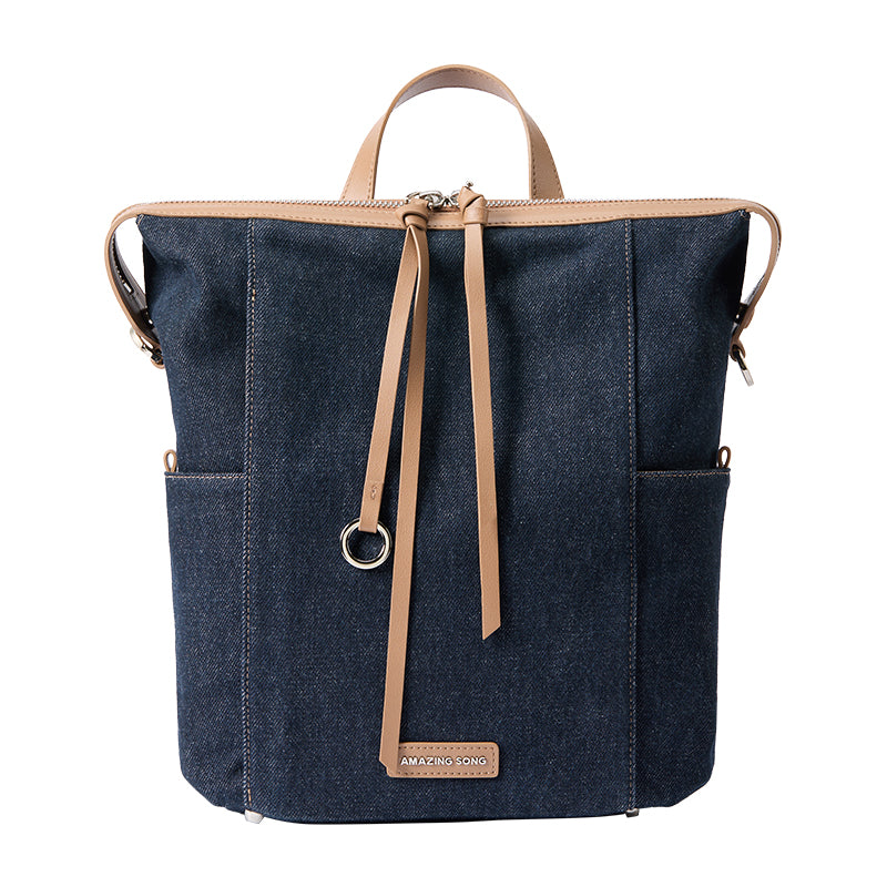 Amazing Song denim backpack with tan leather straps and front logo patch