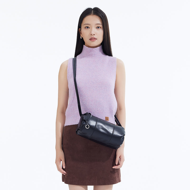 Woman in sleeveless lavender top and brown skirt wearing black crossbody bag, Amazing Song