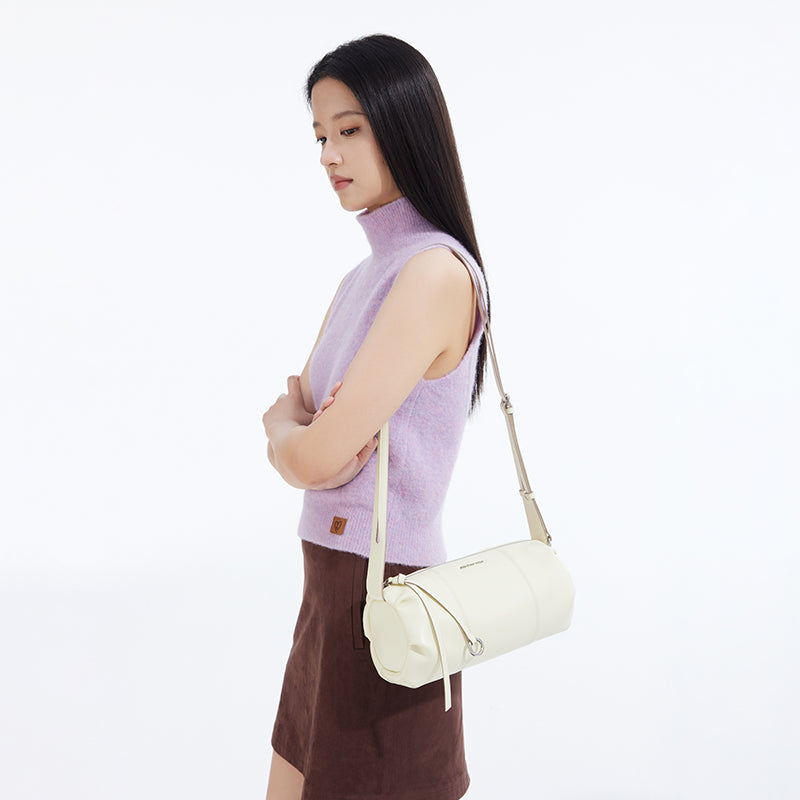 Woman in lilac turtleneck and brown skirt with cream shoulder bag, Amazing Song style