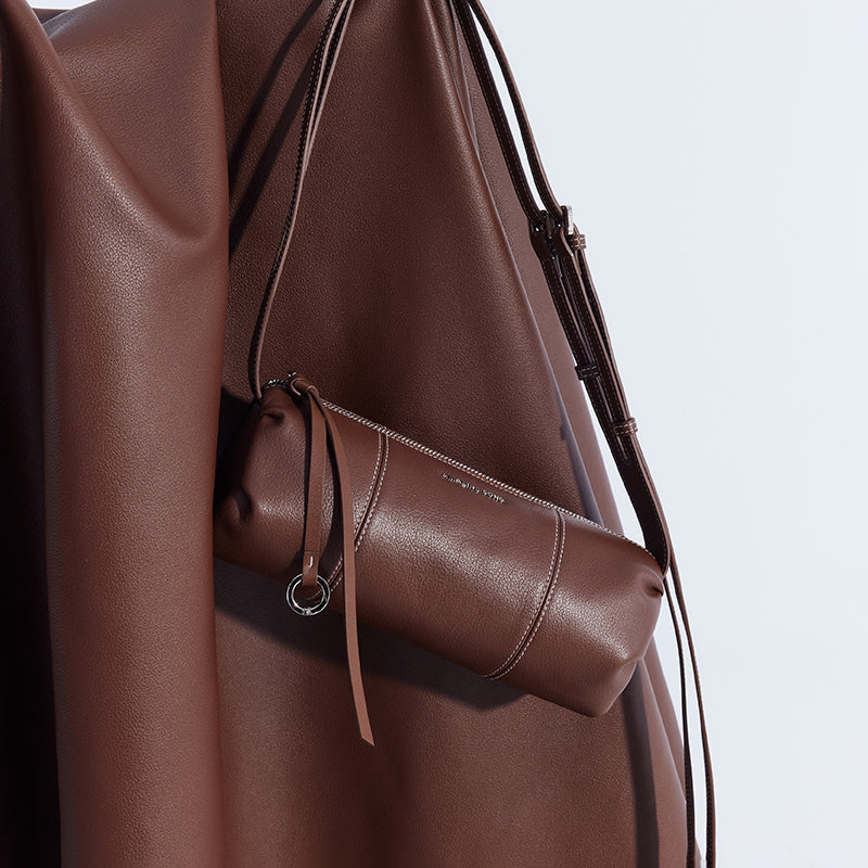 Brown leather crossbody bag with strap on matching brown draped leather, Amazing Song