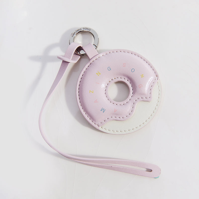 Amazing Song pastel pink donut-shaped keychain with wrist strap on white background