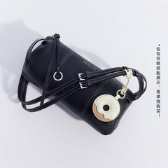 Black Amazing Song shoulder bag with donut-shaped keychain on white background
