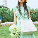 Woman in green dress with white handbag holding flowers outdoors, Amazing Song style