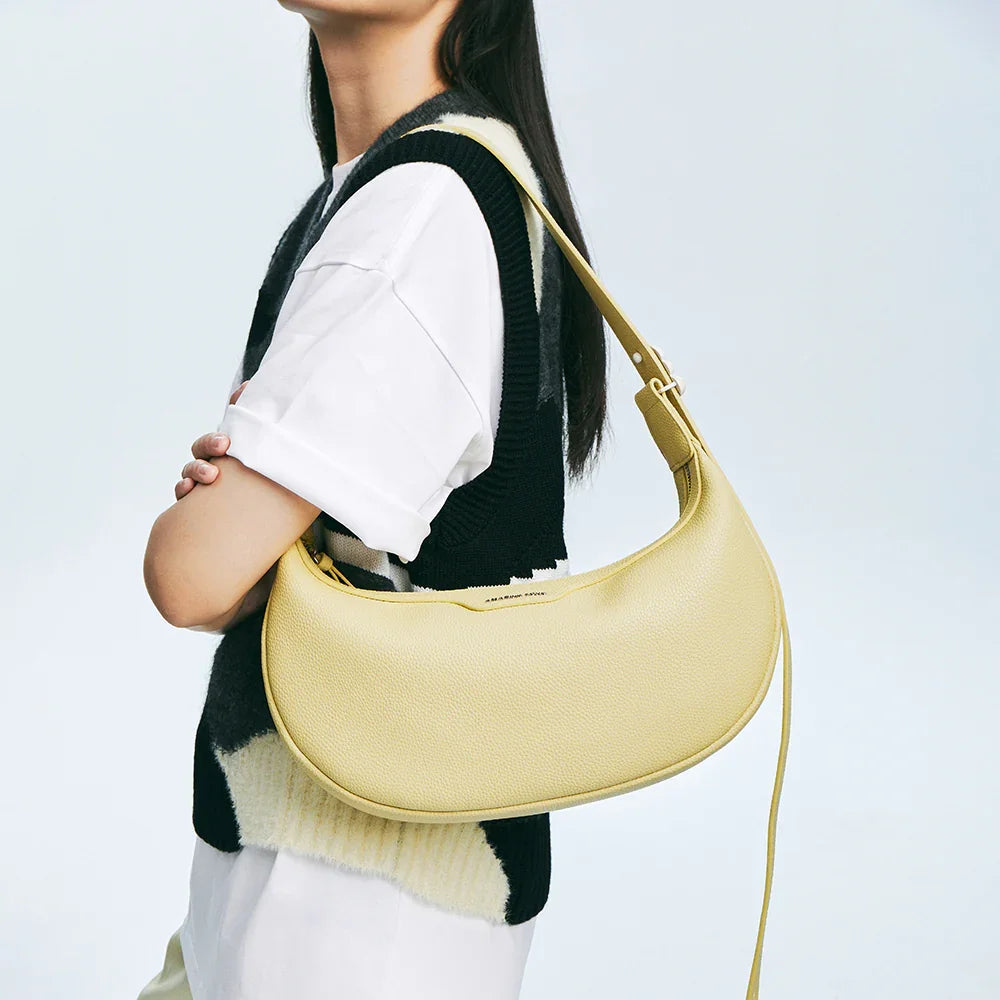 Woman with yellow shoulder bag, white shirt, and Amazing Song branding, minimalist style