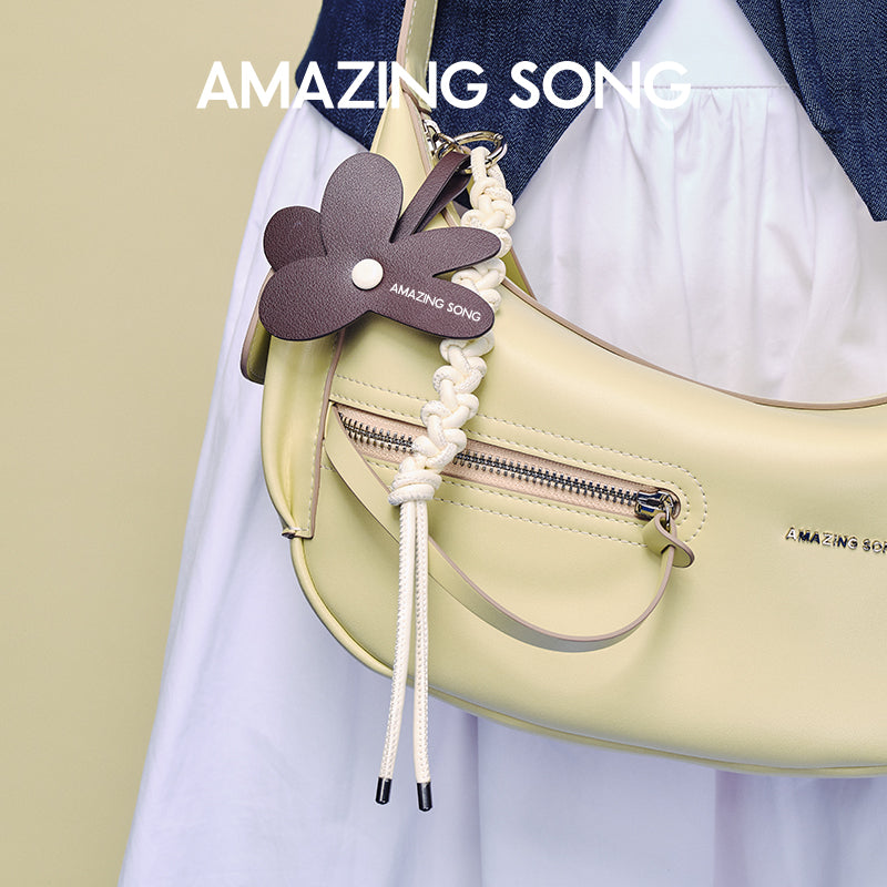 Amazing Song yellow shoulder bag with flower keychain and braided rope detail