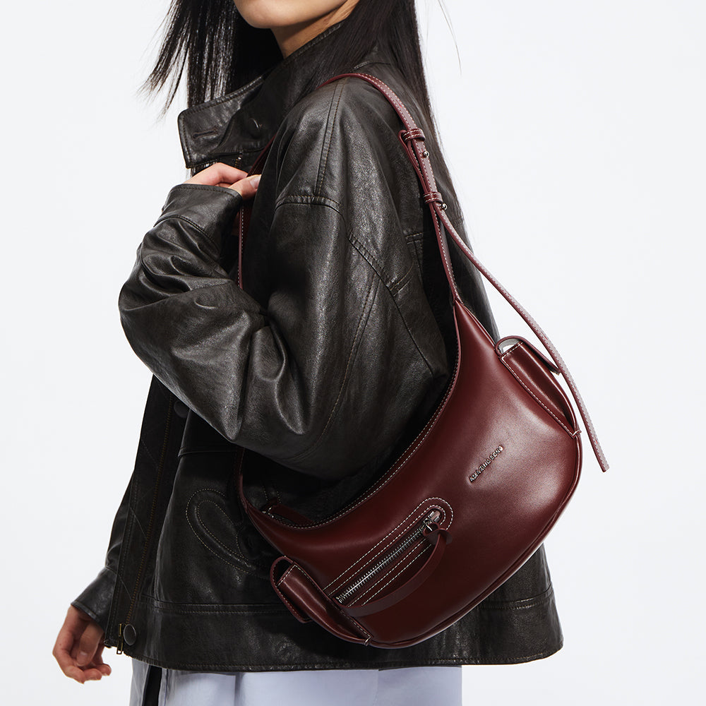 Woman wearing black leather jacket with burgundy leather shoulder bag, Amazing Song style