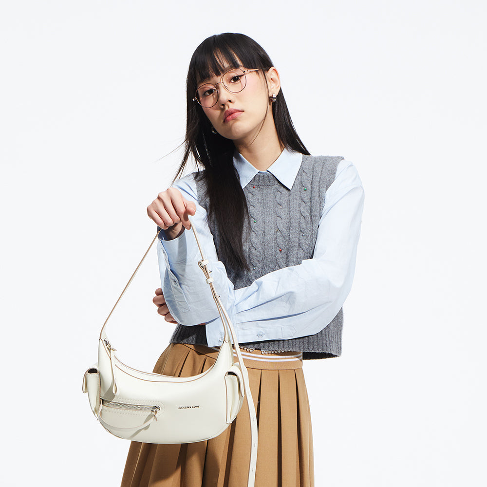 Woman in glasses holding a white shoulder bag, styled in preppy outfit, Amazing Song fashion