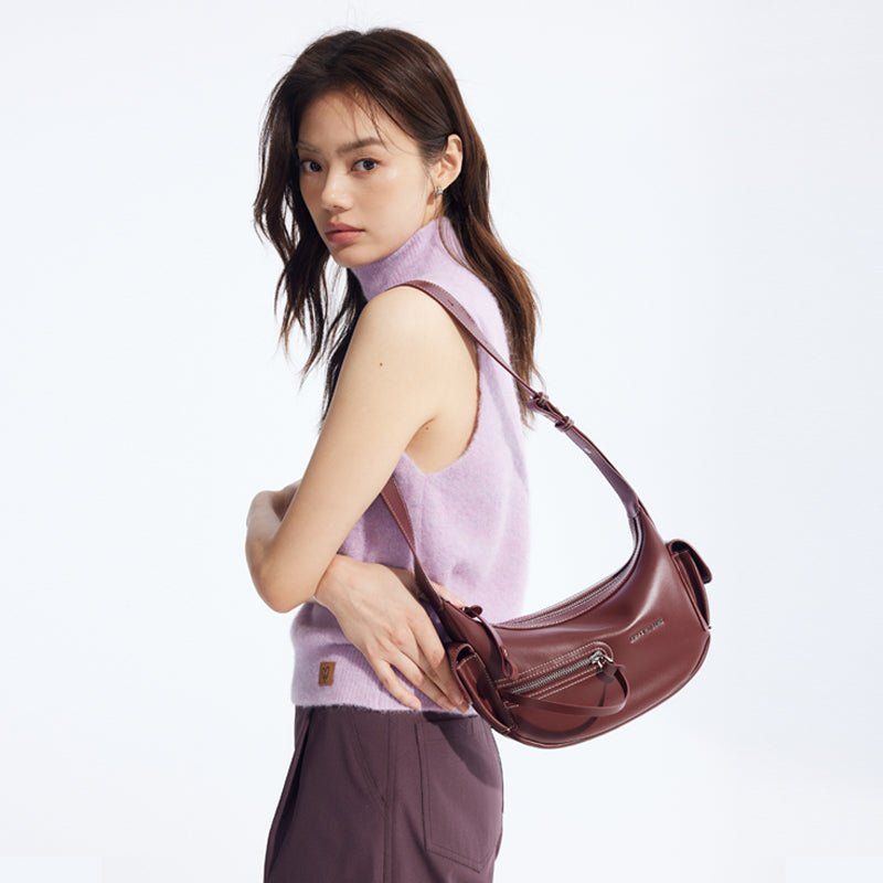 Woman in lilac sleeveless top with burgundy shoulder bag, Amazing Song fashion accessory