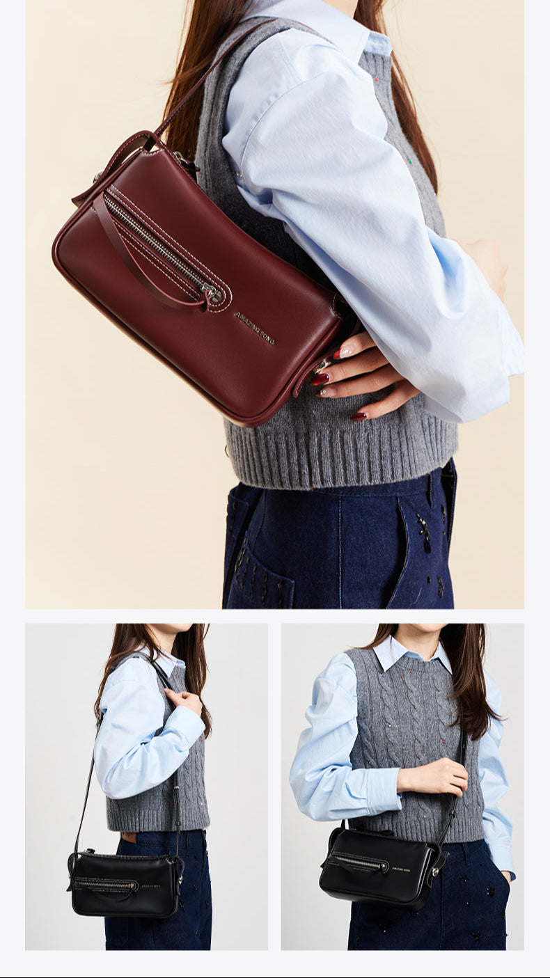 Woman modeling Amazing Song shoulder bag in burgundy and black, stylish accessory fashion.