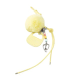 Yellow fluffy pom pom keychain with heart charm and Amazing Song tag on white background