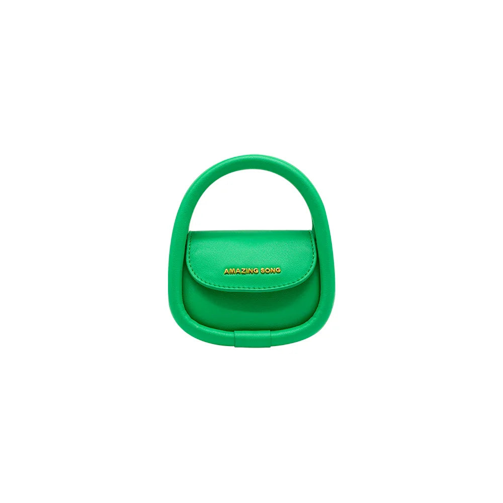 Amazing Song green mini handbag with top handle and gold logo on white background