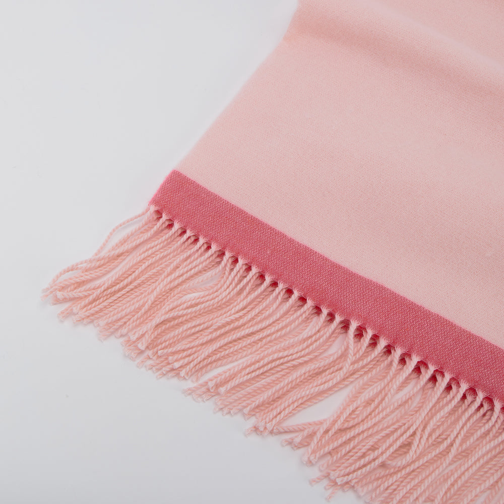 Soft pink woven scarf with fringe edging, showcased on Amazing Song official website