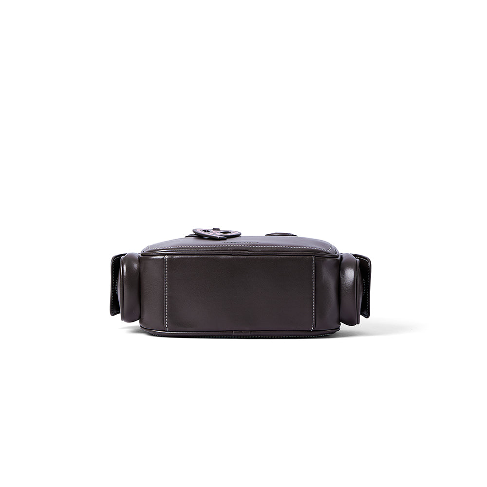 Sleek dark leather crossbody bag with side pockets, featured on Amazing Song official website