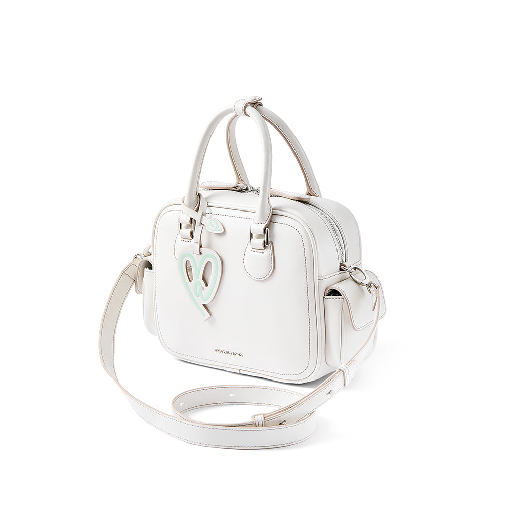 White square handbag with double handles, mint heart accent, and Amazing Song logo